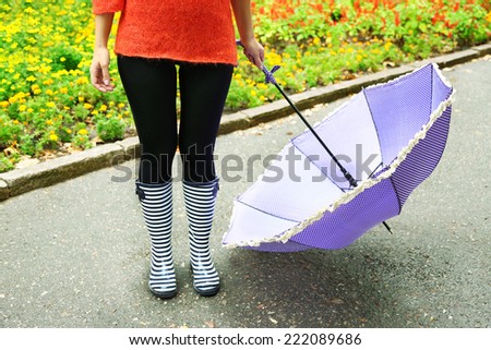Woman in Boots on rainy autumn day.