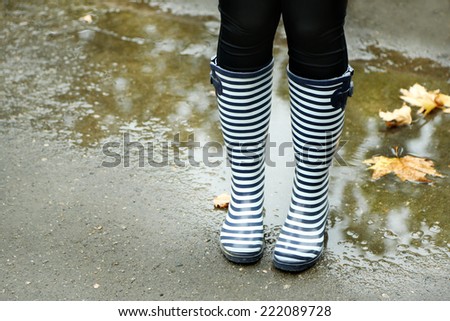 Woman in Boots on rainy autumn day.