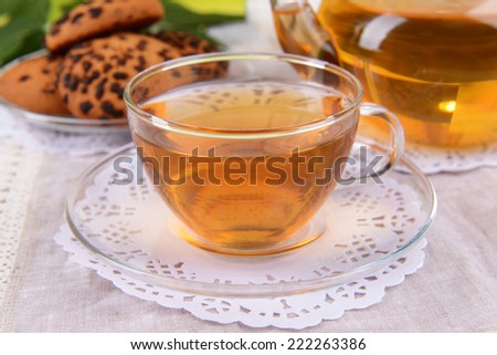 Teapot and cup of tea on table close+up