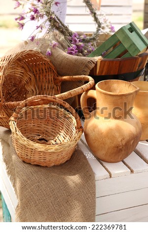 Wicker baskets and pitcher on wooden box