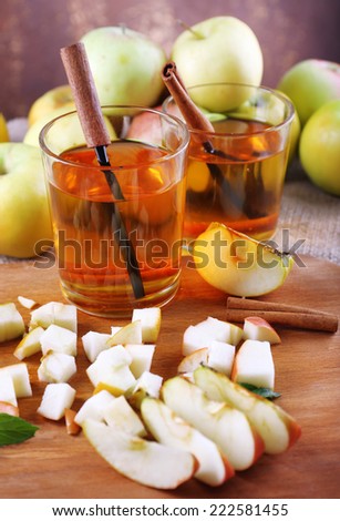 still life with apple cider and fresh apples on wooden table