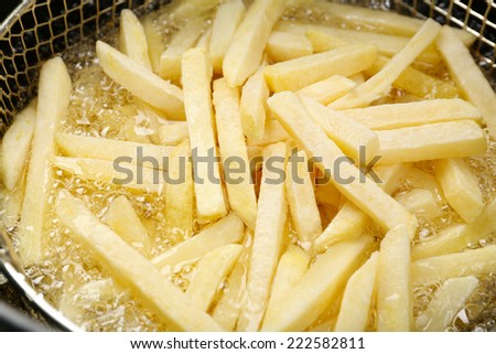 French fries in deep fryer, closeup