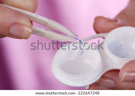 Woman holding container with contact lenses, close-up