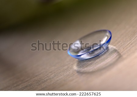 Contact lens on color background