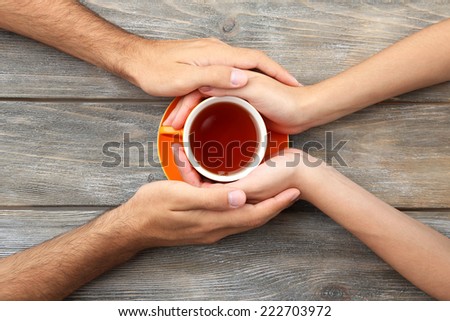 Loving couple with hot drink on table