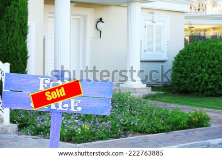 Sold home for sale real estate sign and beautiful new house