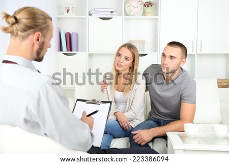Unhappy couple on couch at therapy session