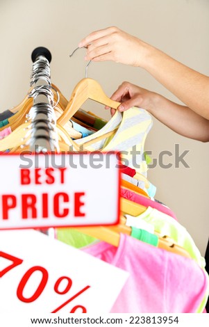 Fashion clothes on shelves in store. Shopping concept