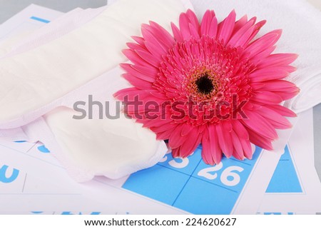 Sanitary pads, and pink Berber and on blue calendar background