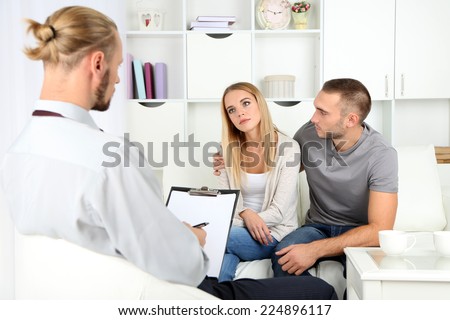 Unhappy couple on couch at therapy session