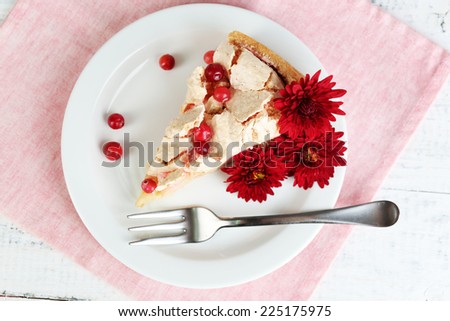 Piece of tasty pie with apples and berry mousse, on wooden background