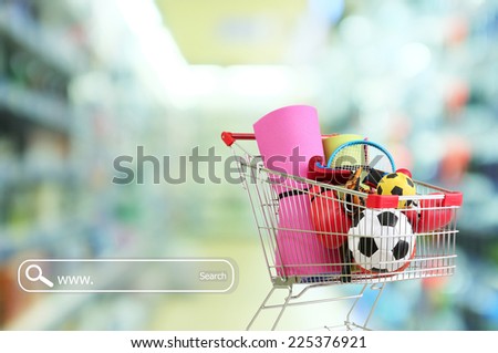 Shopping concept. Shopping cart with sport equipment on shop background