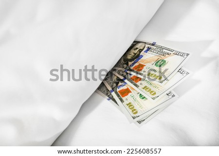 Hidden money under pillow close up