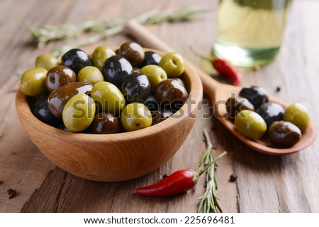 Different marinated olives on table close-up