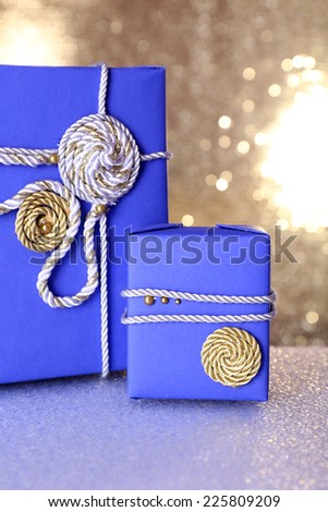 Blue gift boxes on table on shiny background