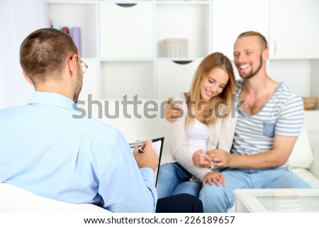 Young happy couple after therapy session with family psychologist