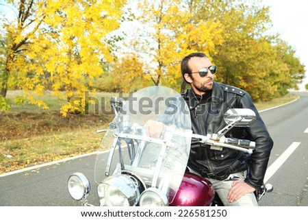Biker man sits on bike