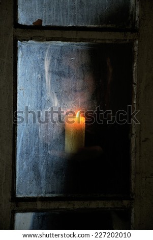 Mystic photo of woman behind  dirty old glass
