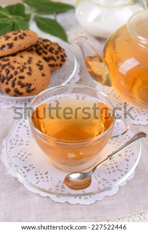 Teapot and cup of tea on table close+up