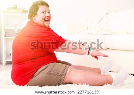 Large fitness man working out at home