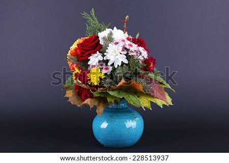 Flower bouquet in blue vase on dark grey background