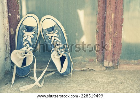 Sneakers on window sill on old window background