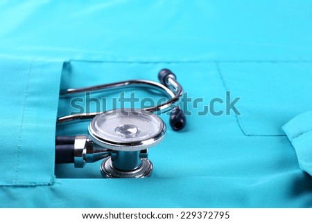 Stethoscope and medical gown isolated on white