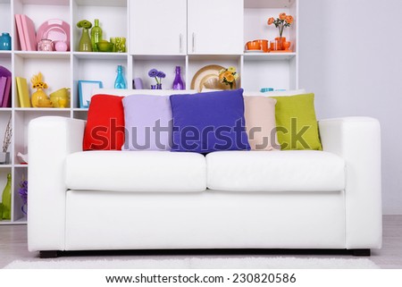 Modern interior design. White living room with sofa and bookcase