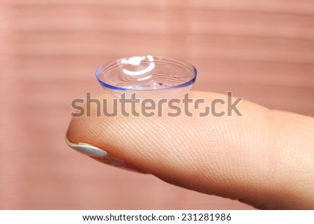 Contact lens on finger, close-up