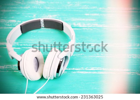 White headphones on wooden table close-up