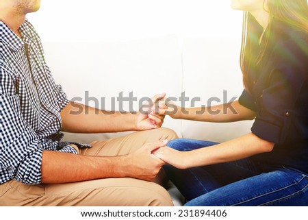 Loving couple holding hands close-up