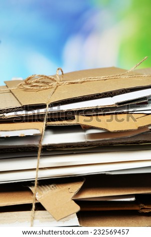 Big stack of papers on blue background, close-up