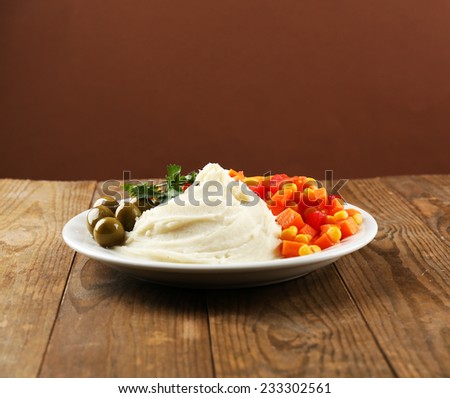 Delicious home cooked food with steam on table on brown background