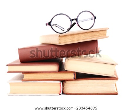 Books in a mess and glasses isolated on white