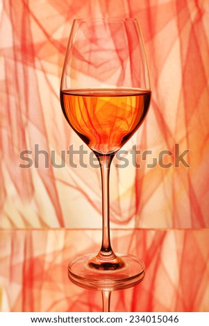 Red wine glass of wine on bright background