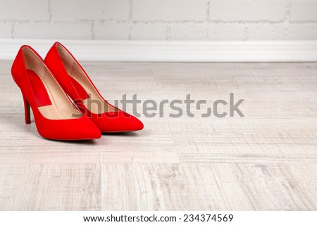 Red women shoes with  on the floor