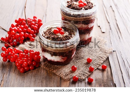 Delicious dessert in jars on table close-up