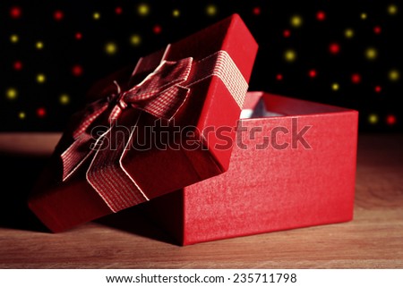 Open gift box on dark background
