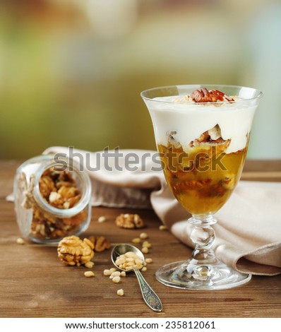Tasty dessert with oat flakes and honey, on table