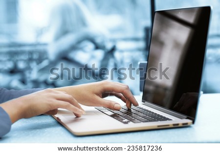 Woman with laptop in cafe shop