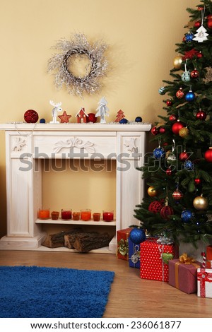 Beautiful Christmas interior with  decorative fireplace and fir tree