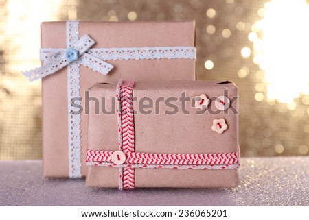 Gift boxes on table on shiny background
