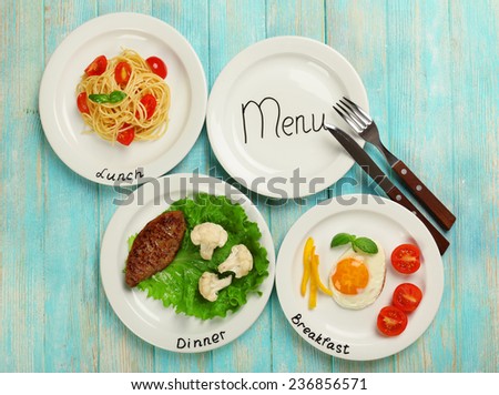 Menu of day. Plates with food on table