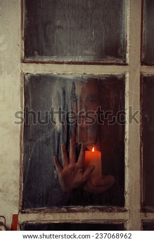 Mystic photo of female hand on  dirty old glass
