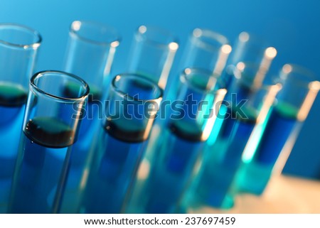 Test-tubes filled with blue and red fluid on the muted background