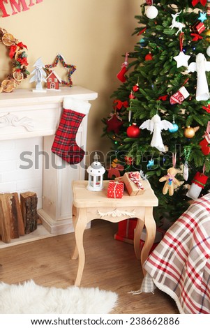 Decorated fireplace near Christmas tree. Christmas decoration concept