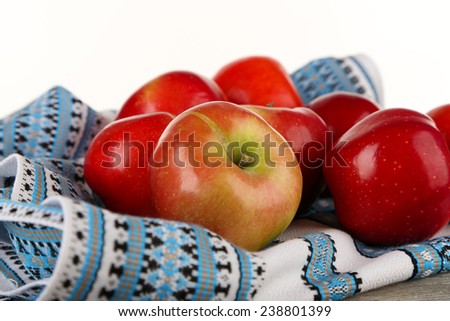 Heap of apples with dish cloth on wooden table isolated on white background