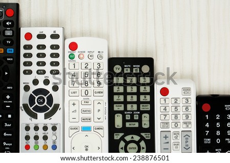 Many remote control devices on table