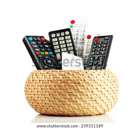 Many remote control devices in container isolated on white