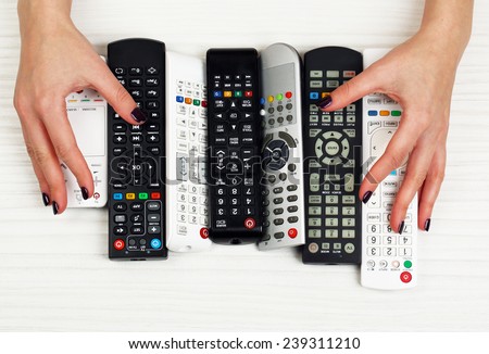 Many remote control devices in hands